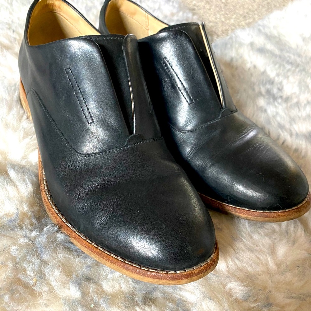 Clarks Black Leather Slip-On Flats with Tan Sole